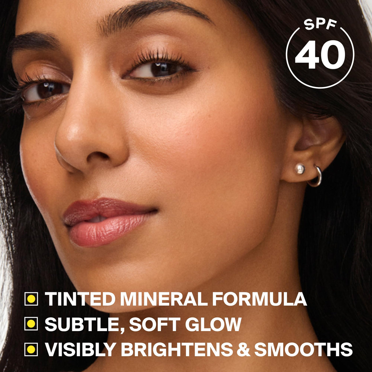 Supergoop! product applied on cheek showing blurred pores and radiant skin benefit