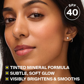 Supergoop! product applied on cheek showing blurred pores and radiant skin benefit