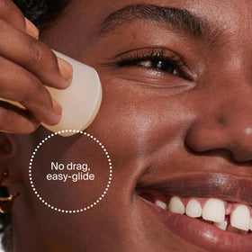 Supergoop! held in hand to show 0.7 fl oz travel-ready size