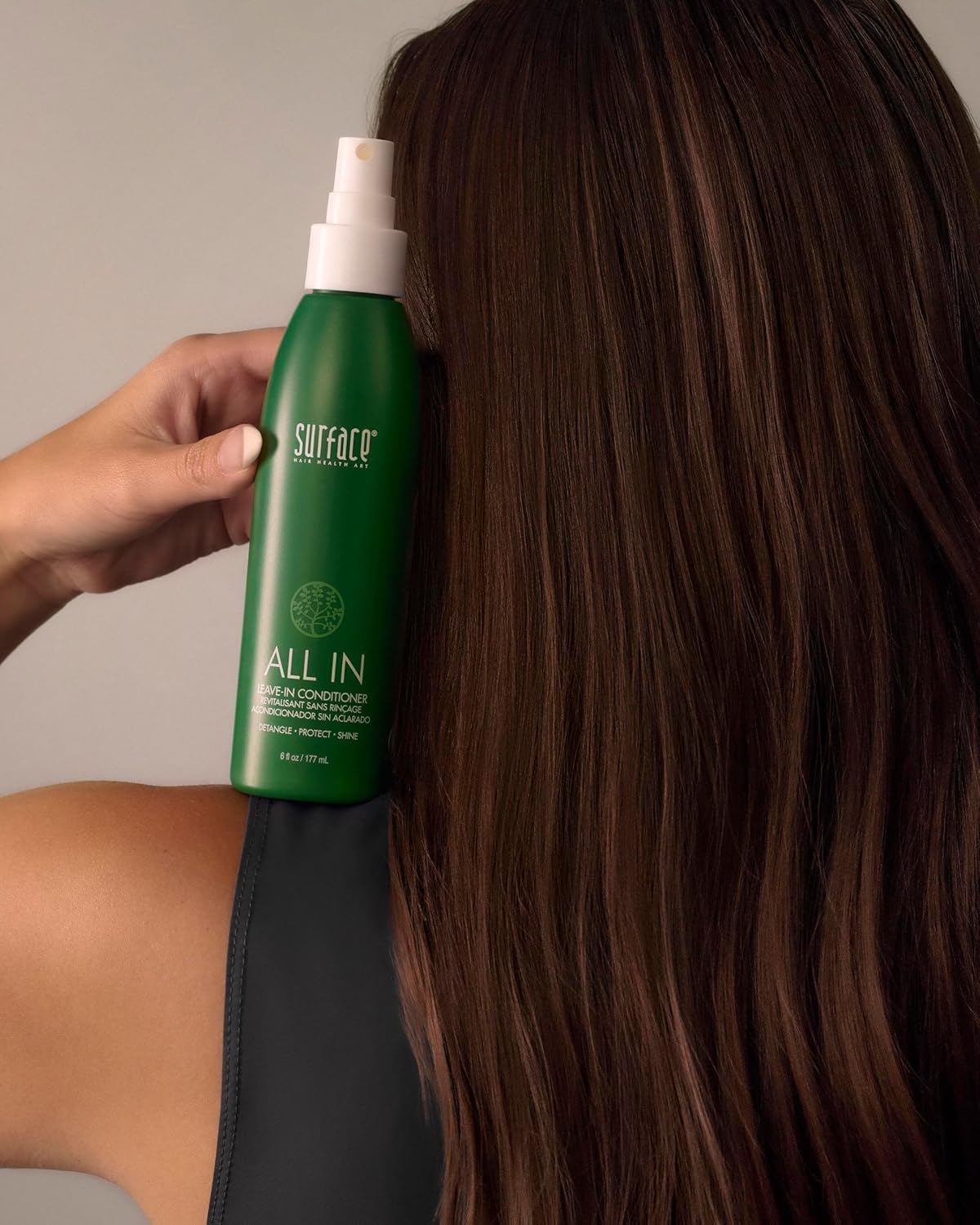 SURFACE bottle in hand to show 6 fl oz scale and travel-friendly convenience