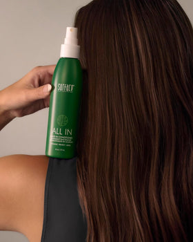 SURFACE bottle in hand to show 6 fl oz scale and travel-friendly convenience