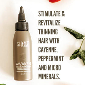 Hand applying SURFACE serum to scalp demonstrating targeted application and convenience