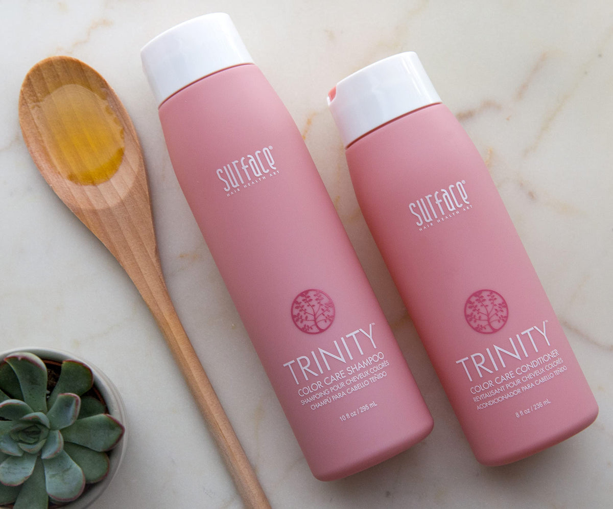 SURFACE Trinity bottle held in hand to show 33.8 fl oz scale and convenience