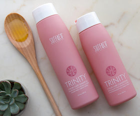 SURFACE Trinity bottle held in hand to show 33.8 fl oz scale and convenience