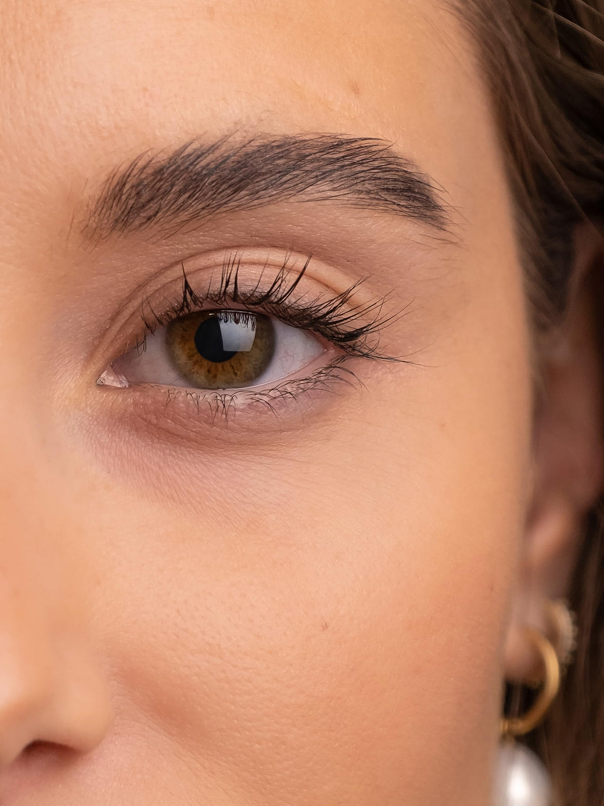 SWEED brow serum clear gel texture droplet showing lightweight absorption benefit