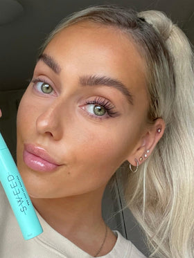 SWEED mascara texture swiped on white for smooth, buildable, glossy finish