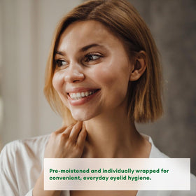 Systane wipe in hand being used on closed eyelid demonstrating easy application benefit