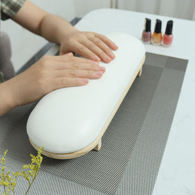 TANG SONG arm rest next to nail tools for scale showing compact size and space-saving benefit
