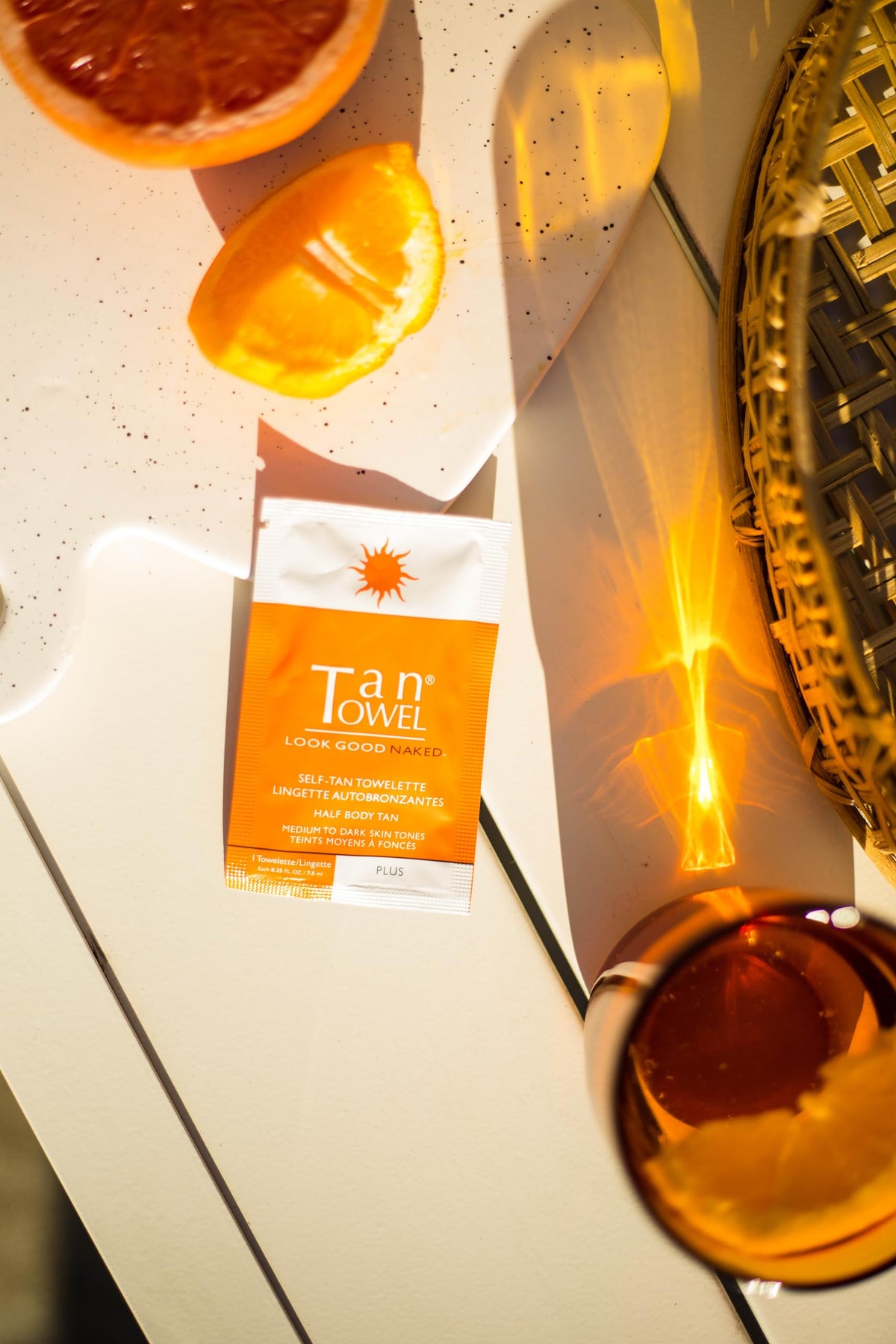 TanTowel close-up of wipe texture highlighting clear liquid for even application
