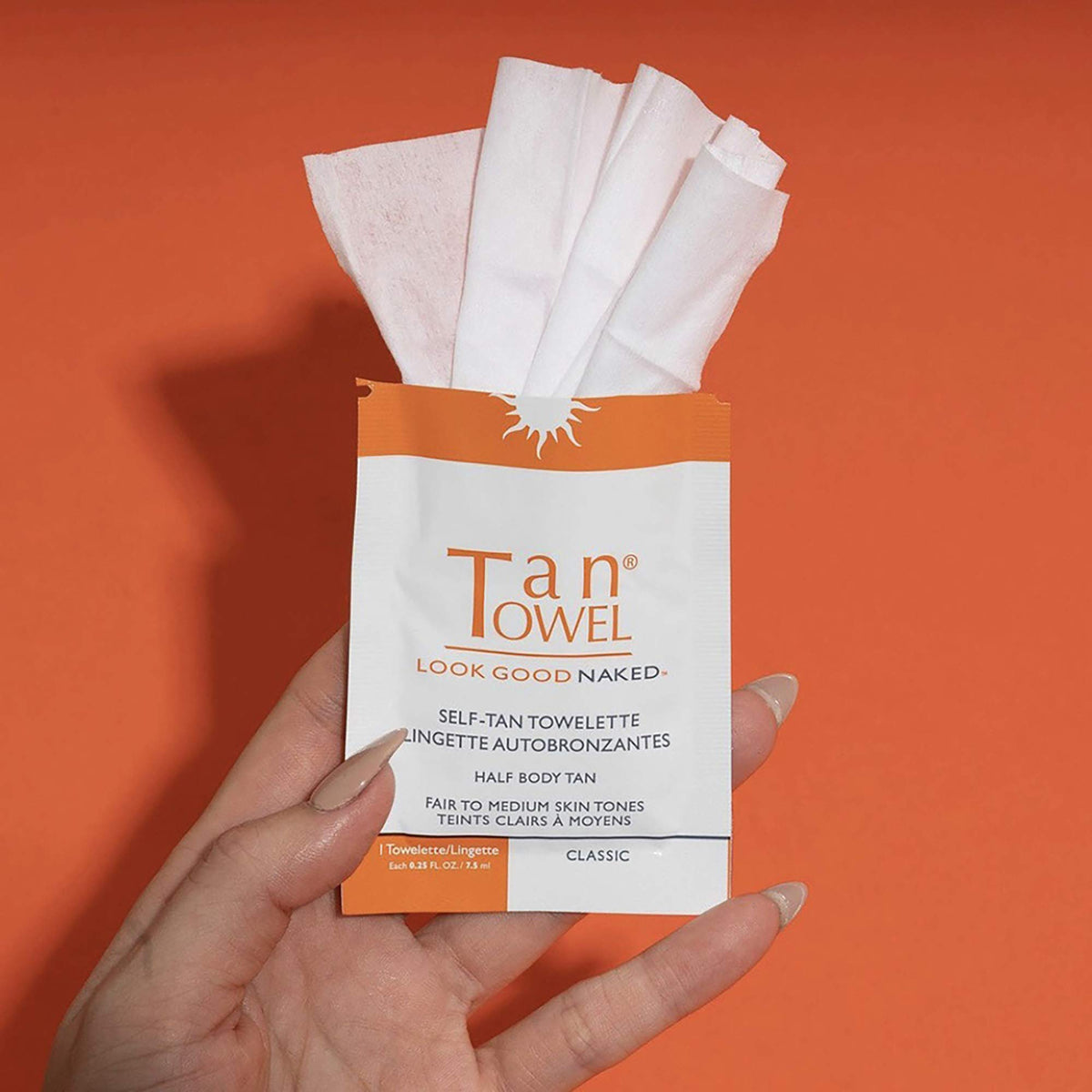 Tan Towel wipe being applied to forearm for even, mess-free sunless tan