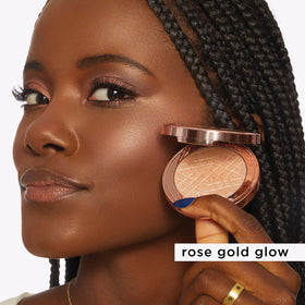tarte applying highlighter to cheekbone demonstrating natural luminous lift