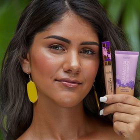 tarte maracuja in hand scale demonstrates compact full-size bottle and travel-friendly size