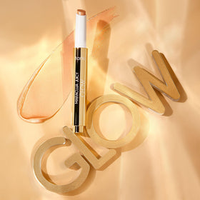 tarte pen held next to fingers showing compact, travel-friendly size