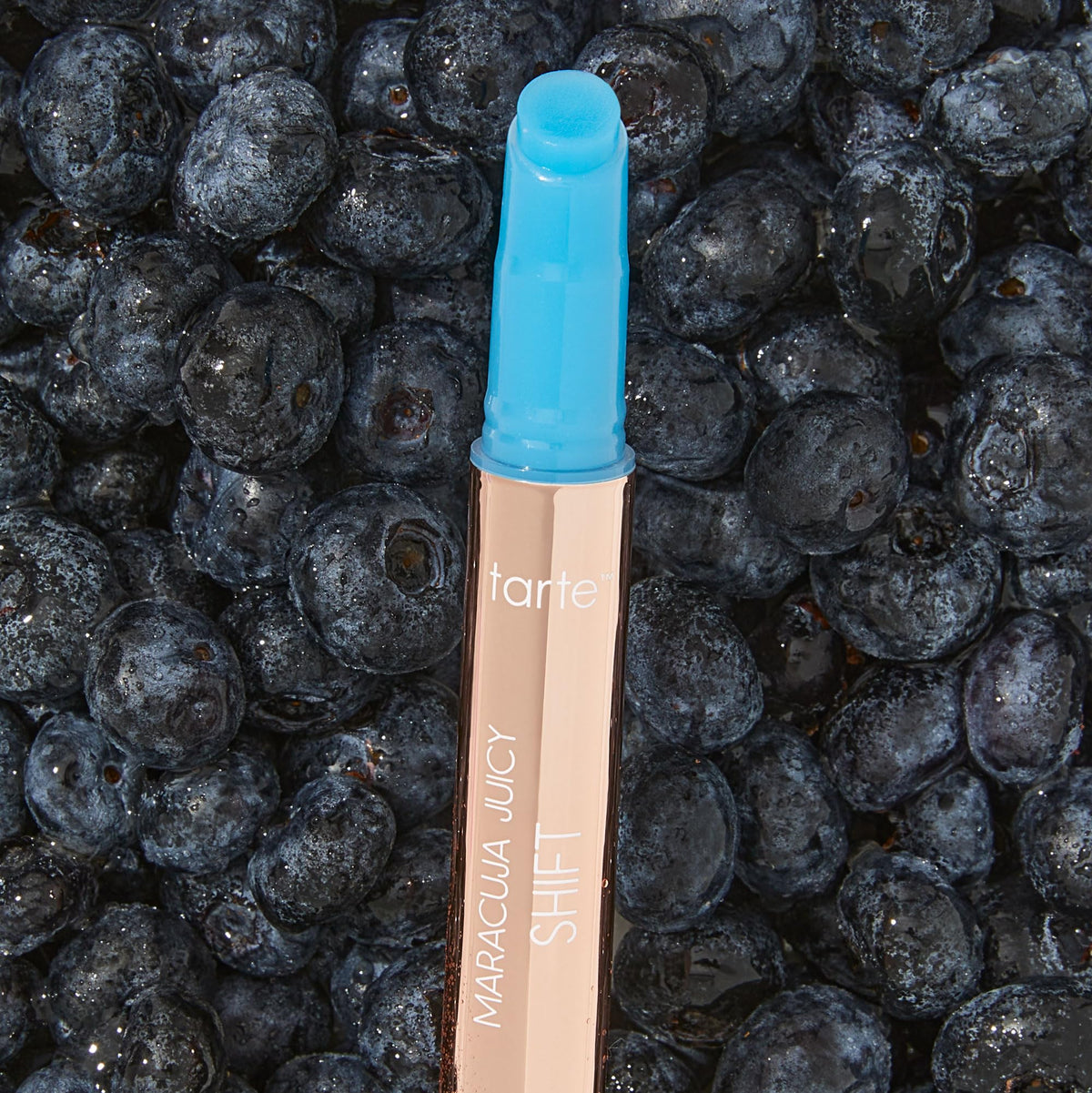 tarte tube next to finger for scale, demonstrating full-size convenience