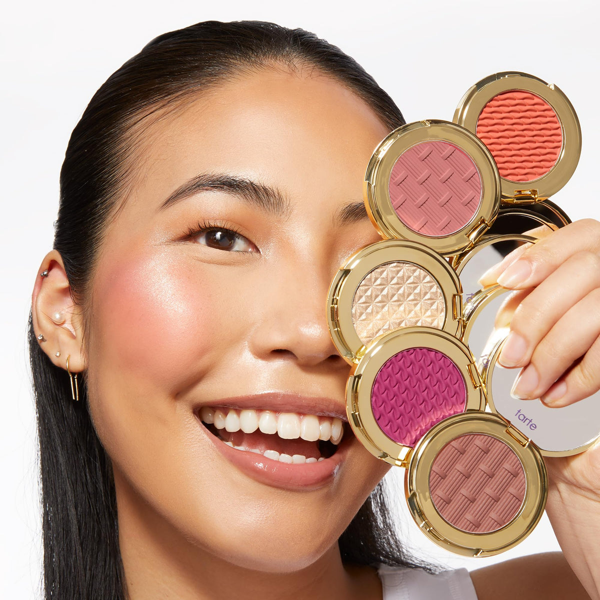 tarte lifestyle shot at a party showing radiant cheeks and effortless touch-ups