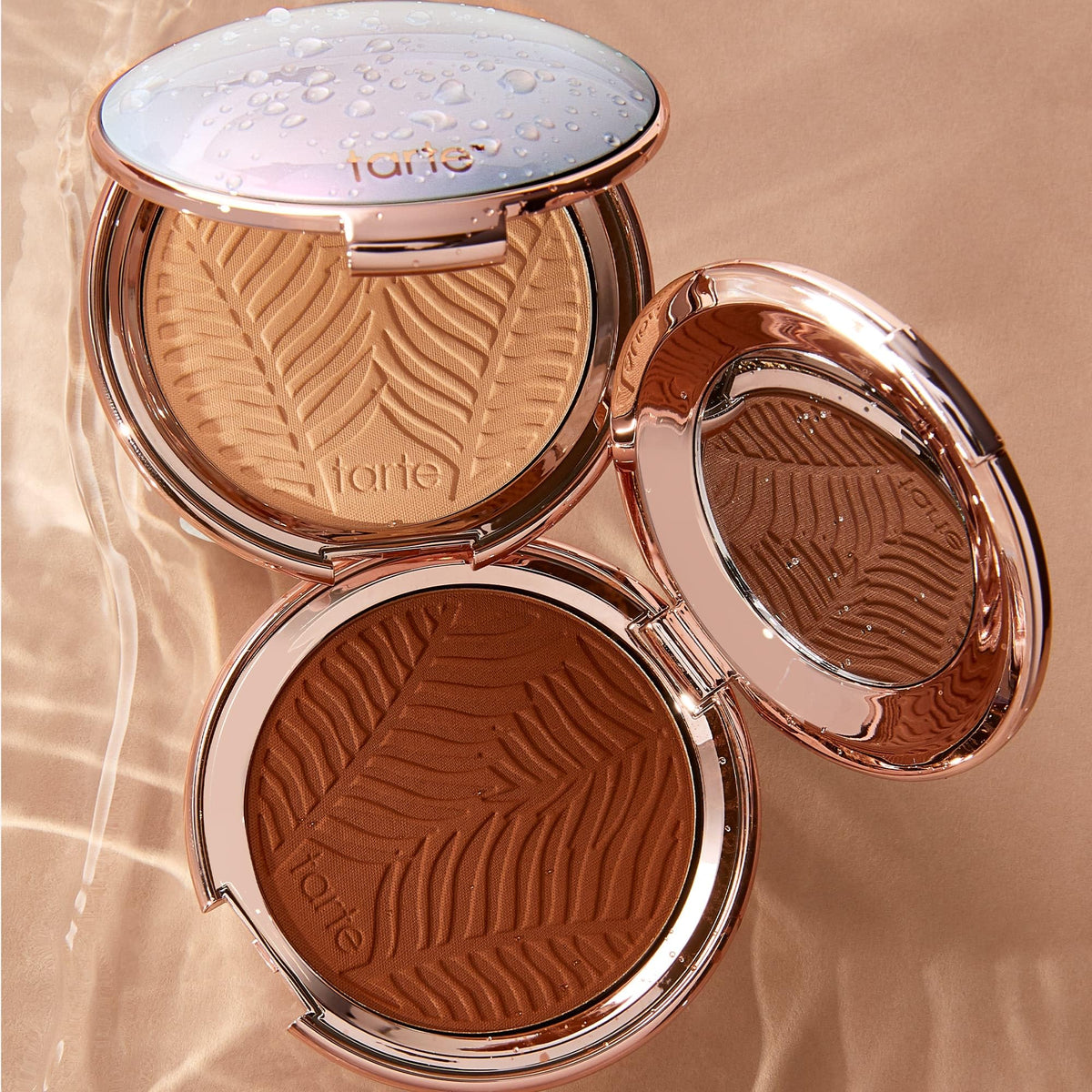 tarte model touching up makeup in a bag showing on-the-go refresh benefit