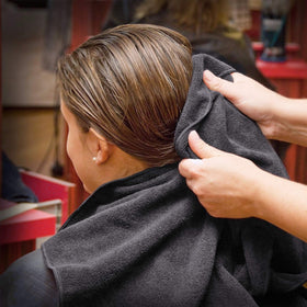 TASALON towels arranged in barber chair setting showing professional, stain-resistant look