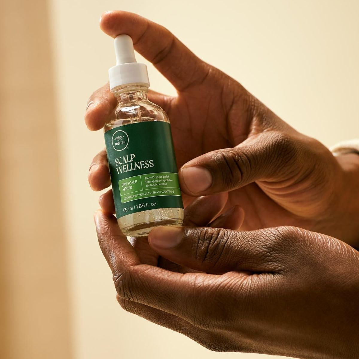 Tea Tree serum dropper dispensing a clear drop, demonstrates controlled application benefit