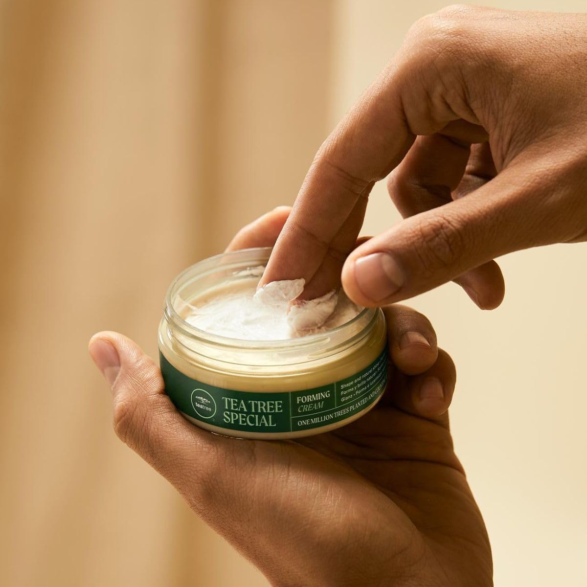 Tea Tree 3 oz size comparison to hand shows compact travel-friendly benefit