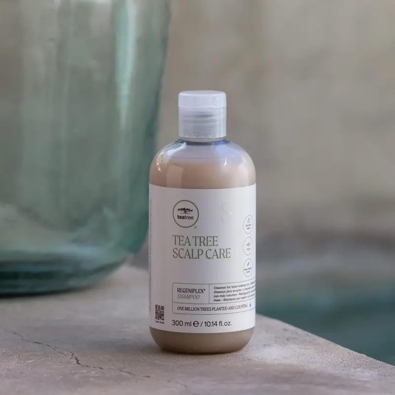 Tea Tree shampoo on bathroom shelf styled to suggest salon-quality routine
