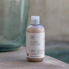 Tea Tree shampoo on bathroom shelf styled to suggest salon-quality routine