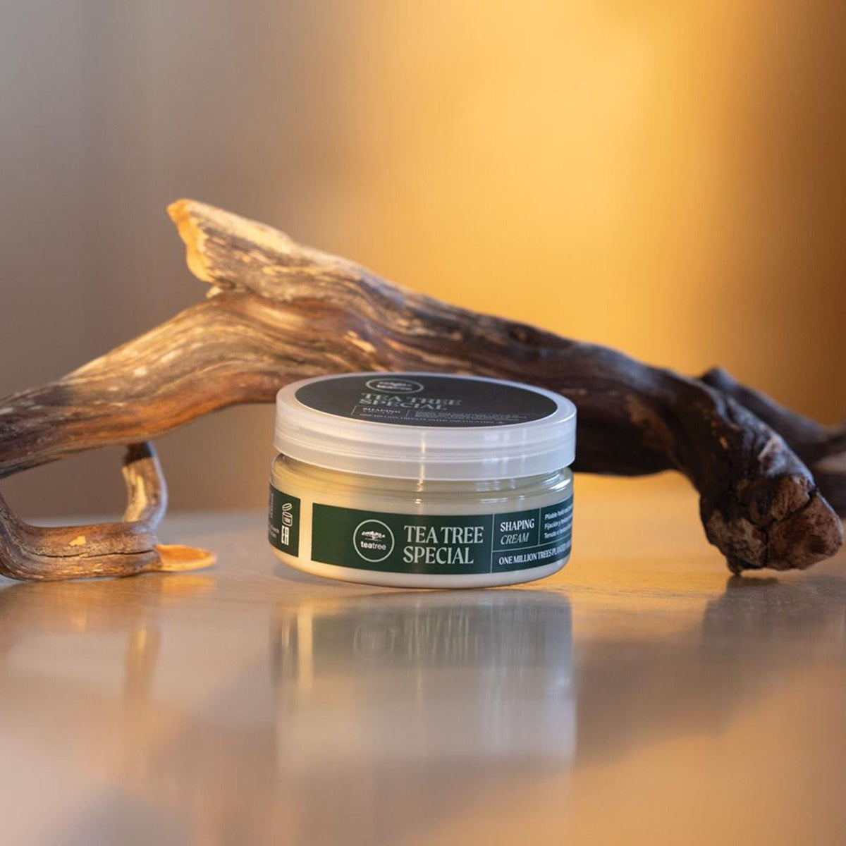 Tea Tree 3 oz jar beside coin for scale, clarifies travel-friendly size