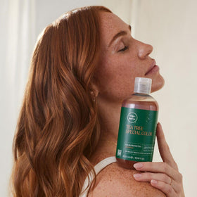 Tea Tree bottle on bathroom shelf conveying refreshing ritual