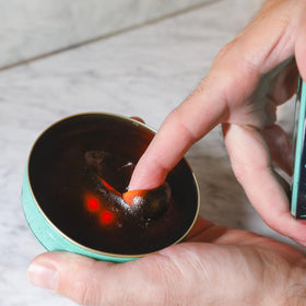 Tenax applied on hands warming product for even distribution benefit