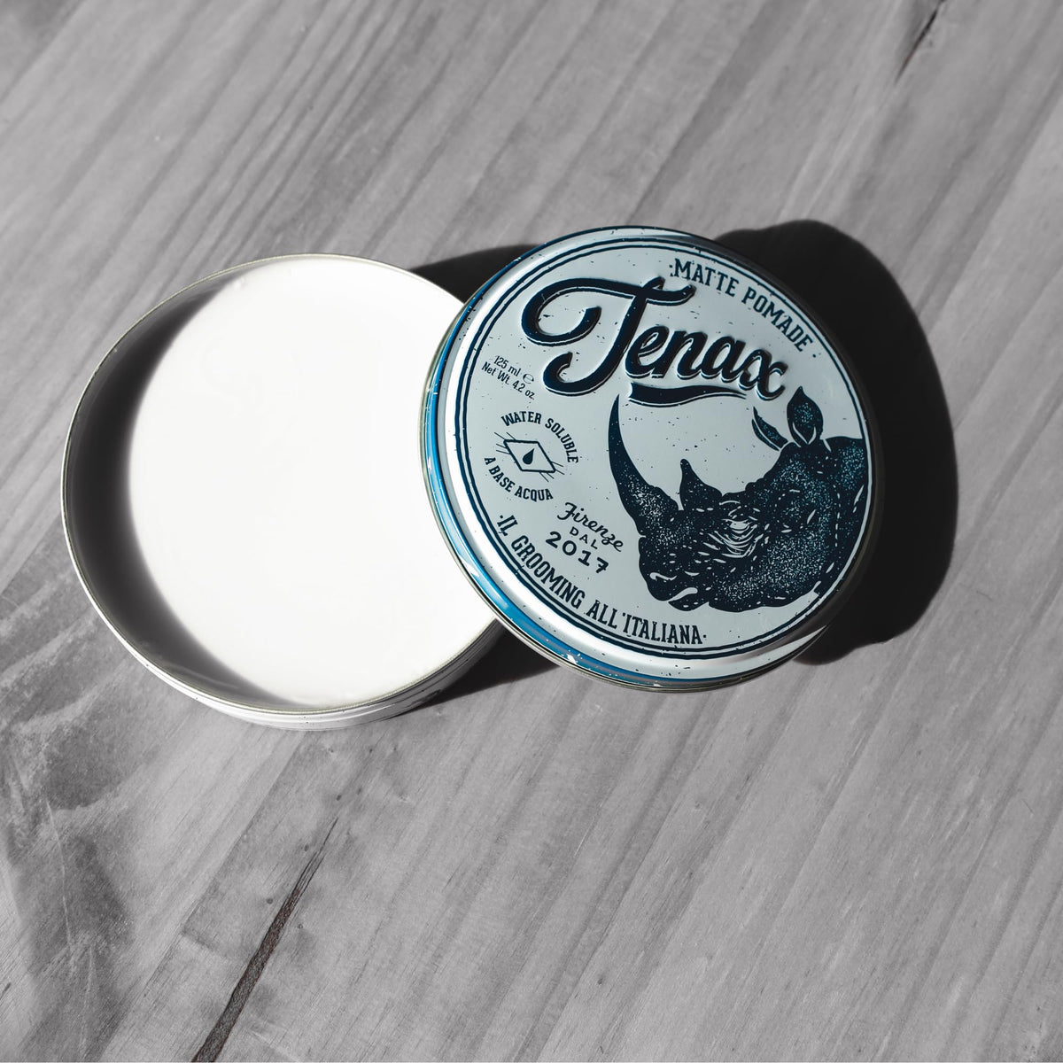 Tenax product being scooped and applied with hands for controlled styling