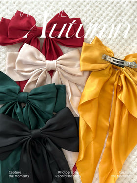 TERSE close-up satin texture of bow for smooth-feel, gentle-on-hair benefit
