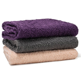 Textila folded stack of three towels showing color set and travel-ready convenience