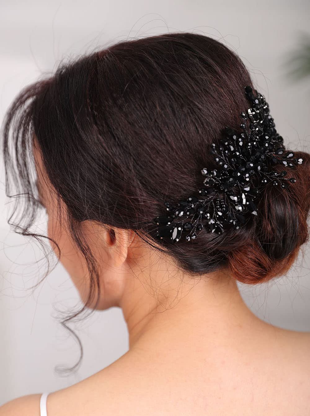 Teyglen front view showing black rhinestone comb and slim alloy frame for refined sparkle