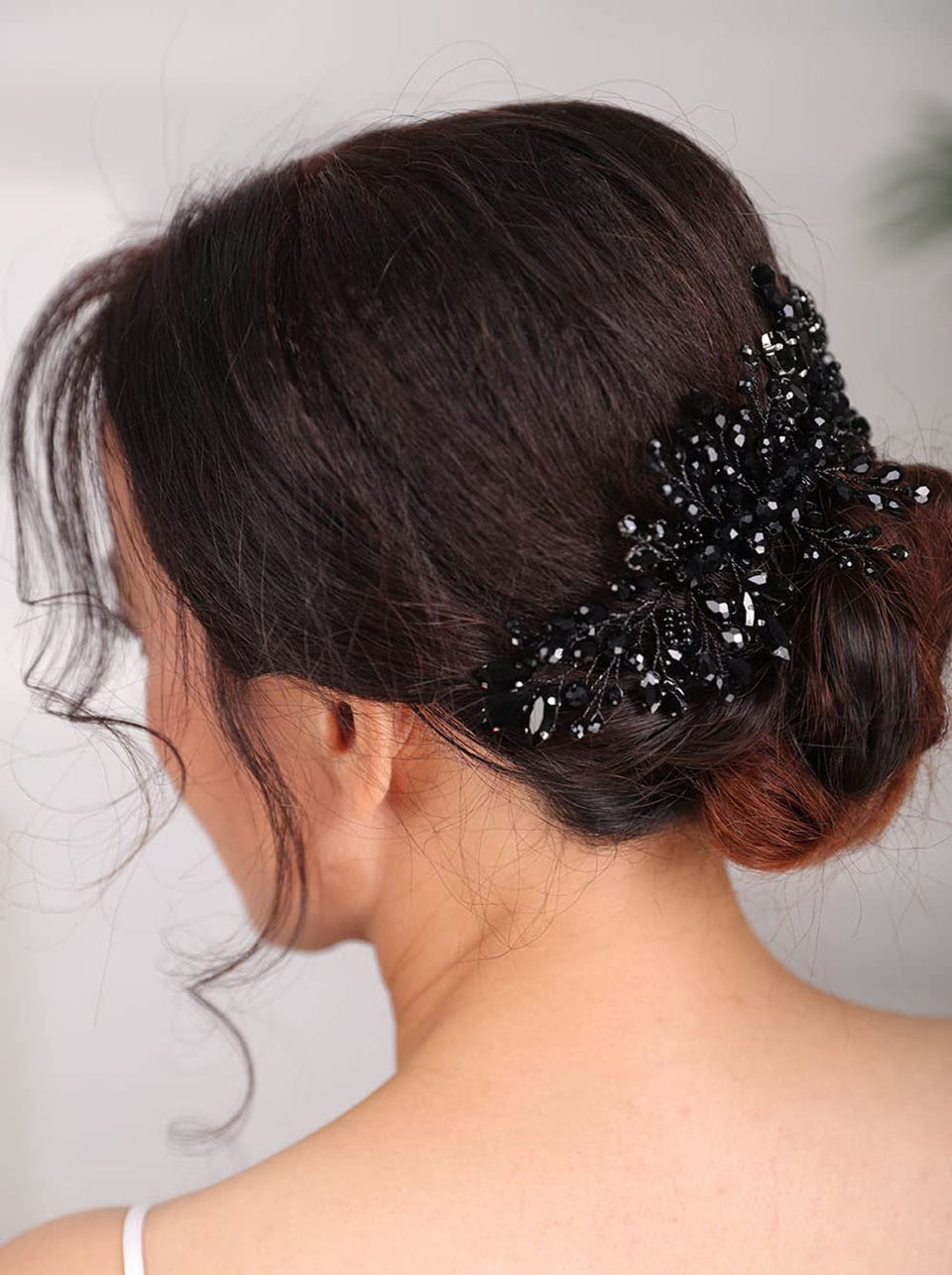 Teyglen front view showing black rhinestone comb and slim alloy frame for refined sparkle