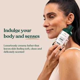 The Body Shop coconut shower cream in hand during use delivering gentle cleansing