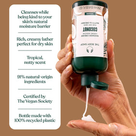 The Body Shop coconut shower cream next to ruler for compact travel-friendly size