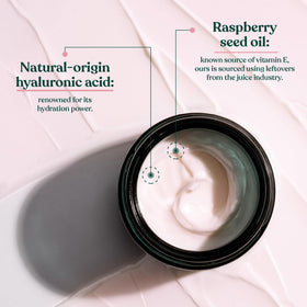 Hand holding The Body Shop cream jar to show scale and ease of use