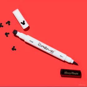 The Crème Shop pen next to free zipper bag in lifestyle setting for organized storage benefit