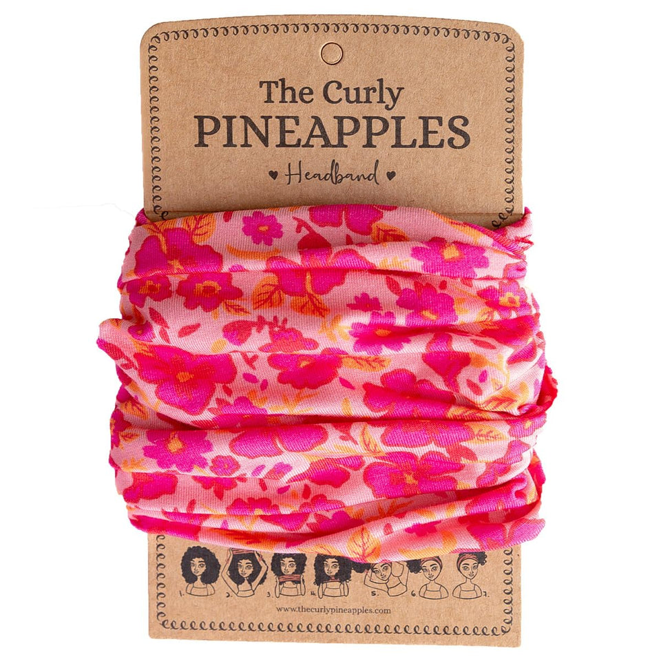 The Curly Pineapples front packaging showing fuschia headband and benefits