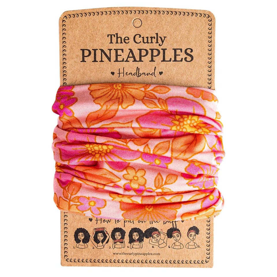 The Curly Pineapples front packaging showing pink coral band and benefit comfort