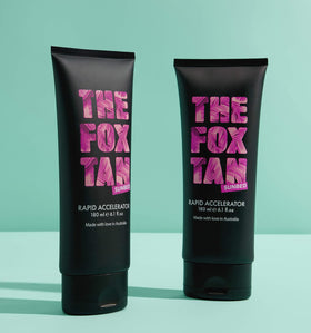 The Fox Tan next to a hand for size comparison showing the 180mL travel-friendly convenience