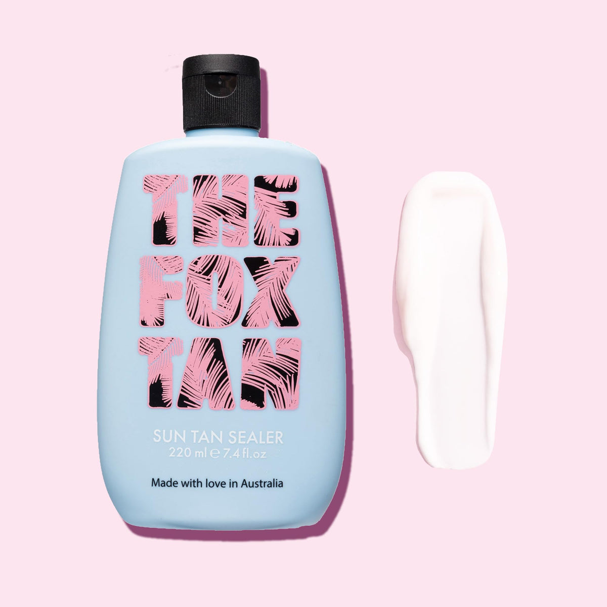 THE FOX TAN bottle held in hand for scale, shows compact 220mL size for travel