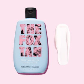 THE FOX TAN bottle held in hand for scale, shows compact 220mL size for travel