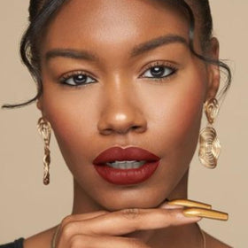 The Lip Bar Brickhouse in a makeup bag suggesting portability and travel-ready benefit
