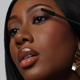 The Lip Bar mascara in a makeup bag lifestyle shot for travel-ready convenience