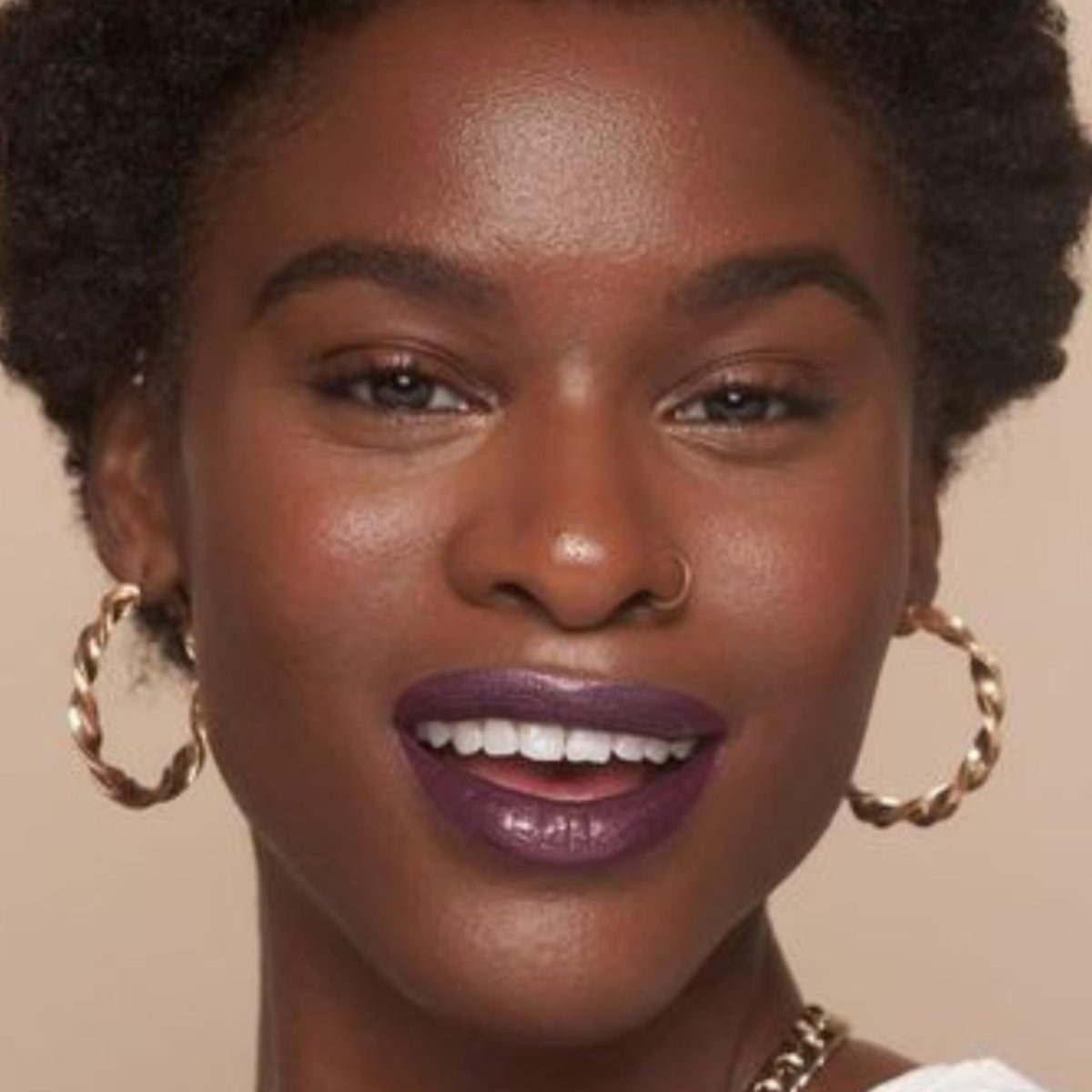 The Lip Bar next to a coin showing compact .24 fl oz size convenience