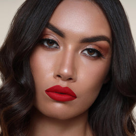The Lip Bar Hot Mama layered with gloss showing shine transformation, versatile styling benefit