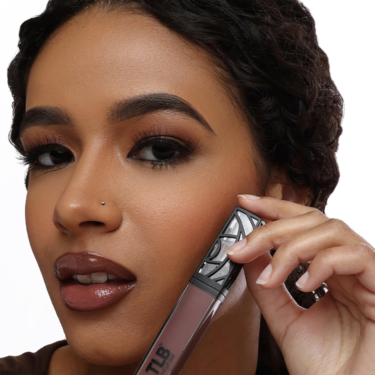 The Lip Bar gloss layered over matte lipstick showing added shine and dimension