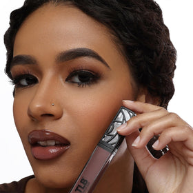 The Lip Bar gloss layered over matte lipstick showing added shine and dimension