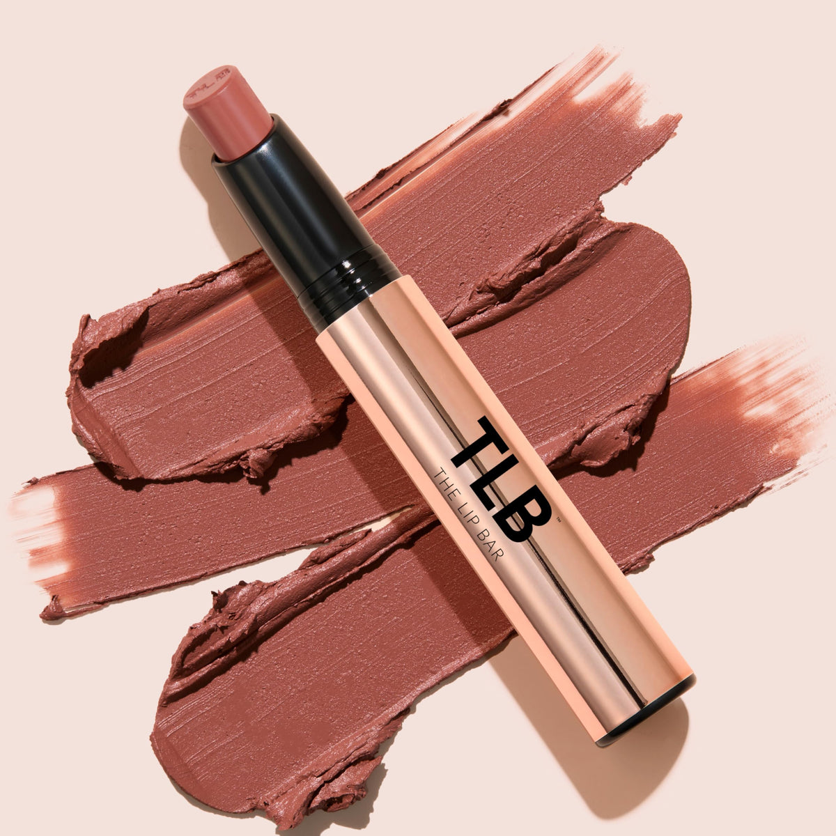 The Lip Bar held in hand to show size and travel-friendly slim profile