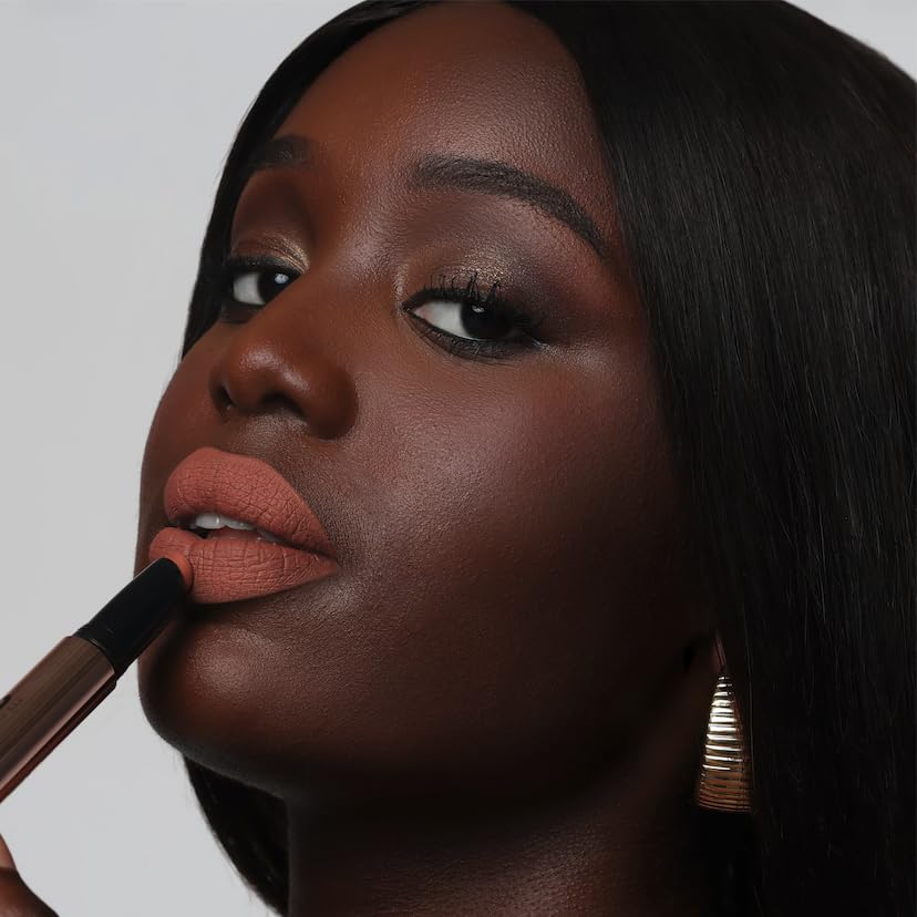The Lip Bar swatch on wrist showing Muse deep berry payoff and blendable finish